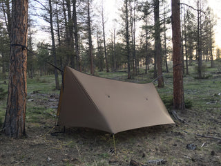 Aufgespanntes Tarp über einer Hängematte im Wald